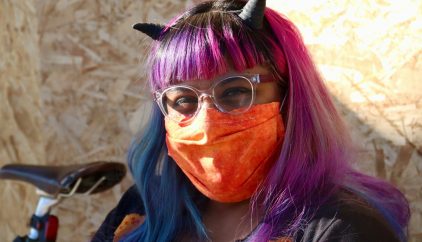 woman with purple hair wearing sunglasses